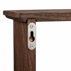 Close up of a metal keyhole hanging plate screwed to the top corner of the dark brown wooden rack