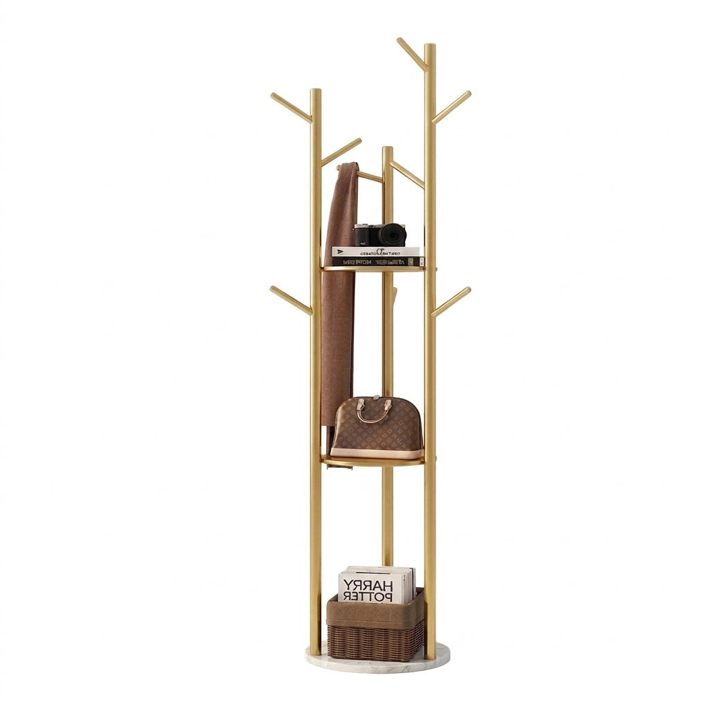 Gold metal tree coat rack with branch hooks, two round shelves and a white marble-look base holding a scarf, bag and basket
