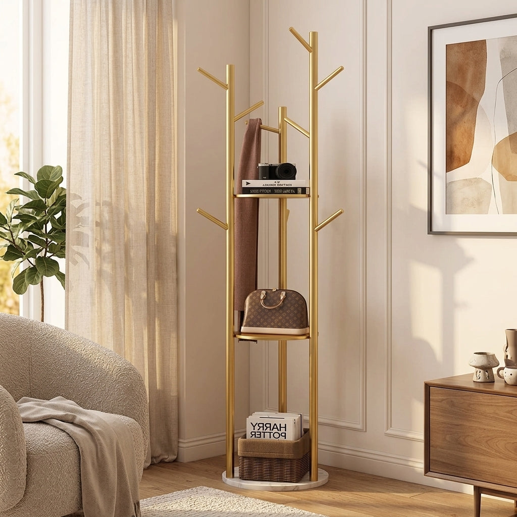 Gold tree coat rack with a white marble-look base in a living room with a scarf on a branch, a bag on a shelf and a basket