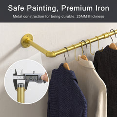 Gold wall mounted pipe clothes rail with gold S-hooks and hangers holding sweaters and shirts, with a pipe diameter close-up